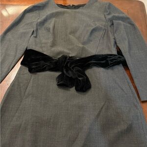 100 wool dress with attached velvet belt on waist.